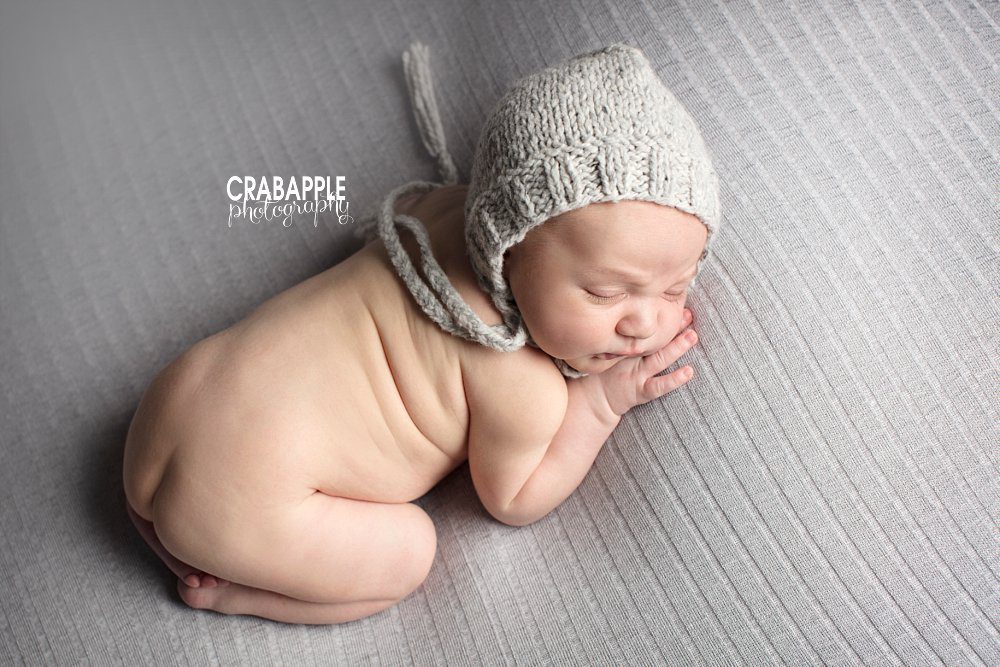 newborn portrait of a sleeping baby boy laying on his tummy wearing a knit hat. Windham NH area newborn photographer