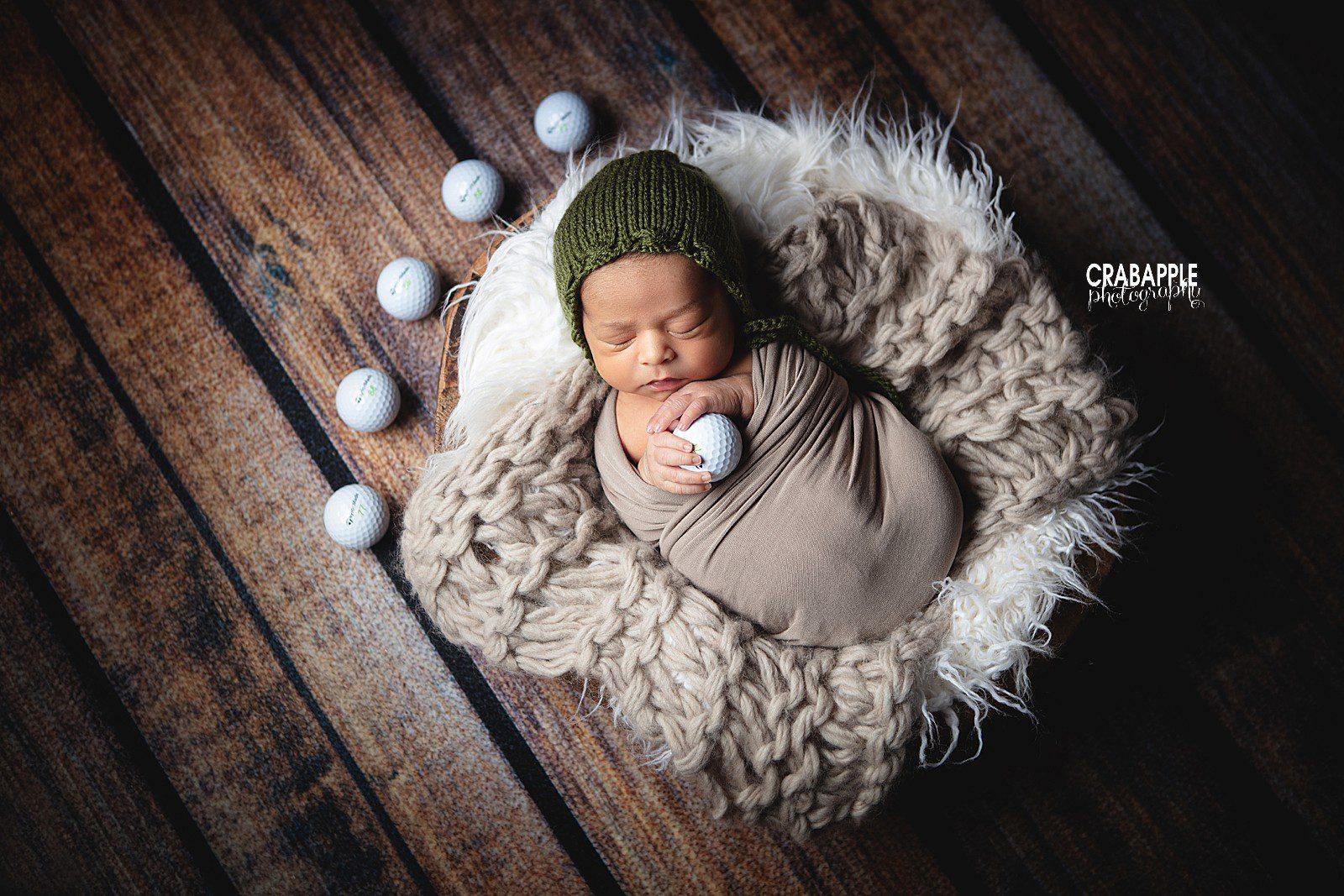 Newborn portrait photography including golf balls