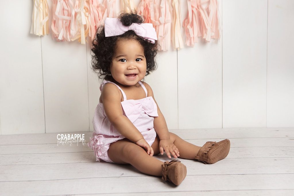 1 Year old girl smiles for camera during Cambridge MA photoshoot