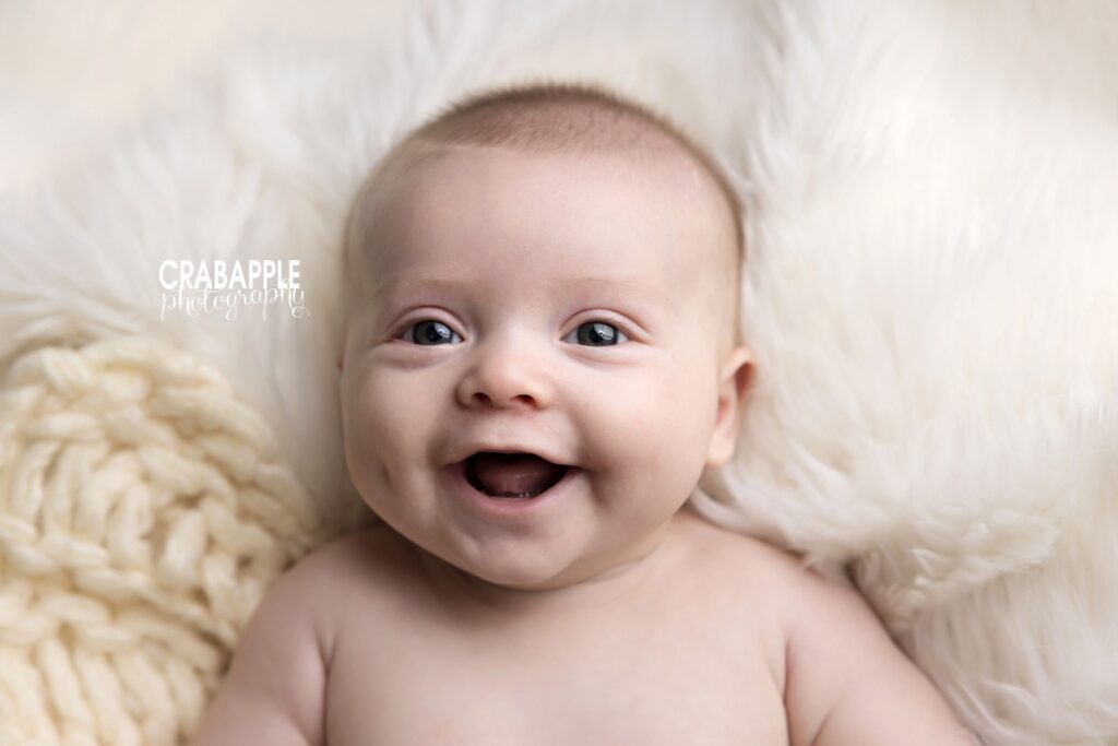 baby milestone photos at 3 months old on neutral backdrop
