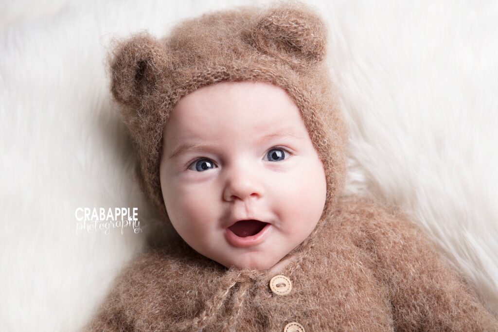 smiling 3 month old baby looking at camera during photo session
