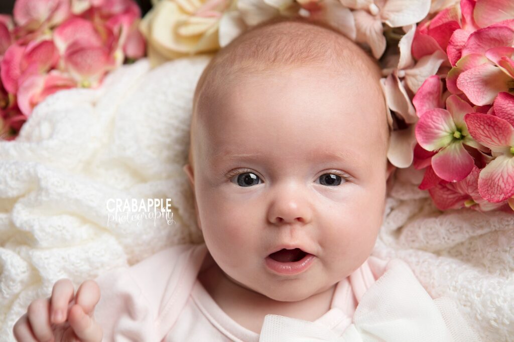 close up baby portrait with floral props