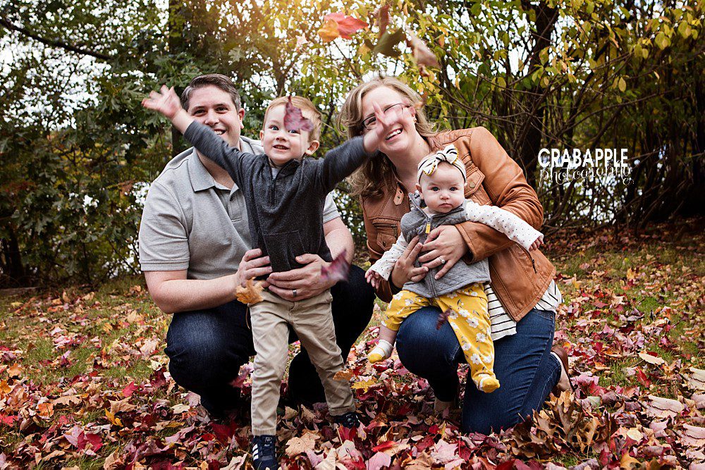 fun outdoor family picture playing in the leaves