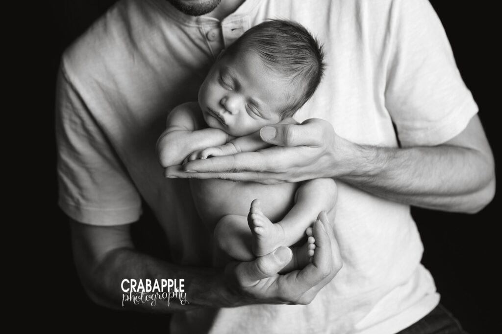 dad's hands holding newborn photo ideas