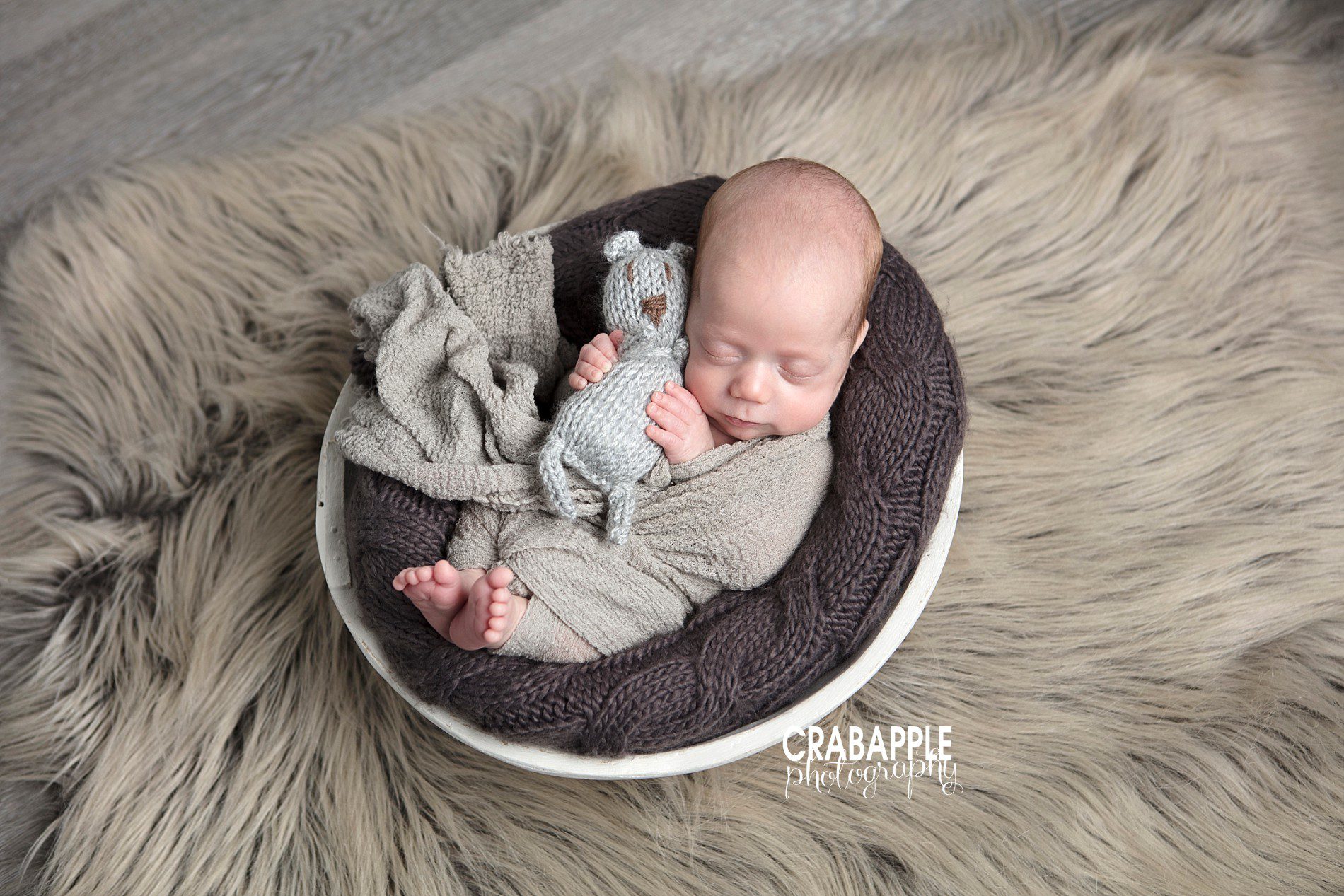 Sweet newborn photo with baby holding stuffed animal baby boy photoshoot ideas 