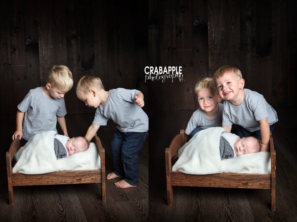 Two vertical portraits collaged together. Newborn baby boy sleeps on a tiny wooden bed while two older toddler brothers stand behind. In one photo they peer down at him, in the other they smile for the camera.