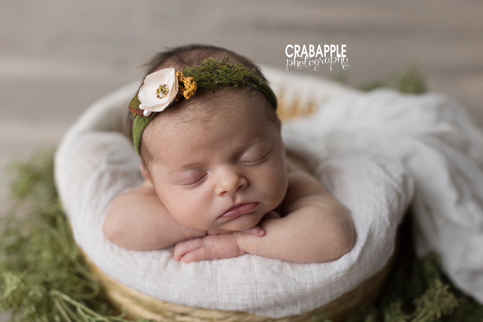 Natural newborn photos using pops of white, green, and beige