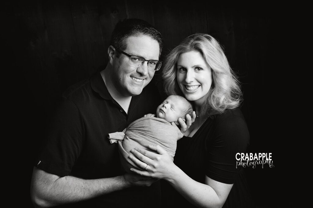 black and white family photo with newborn son.