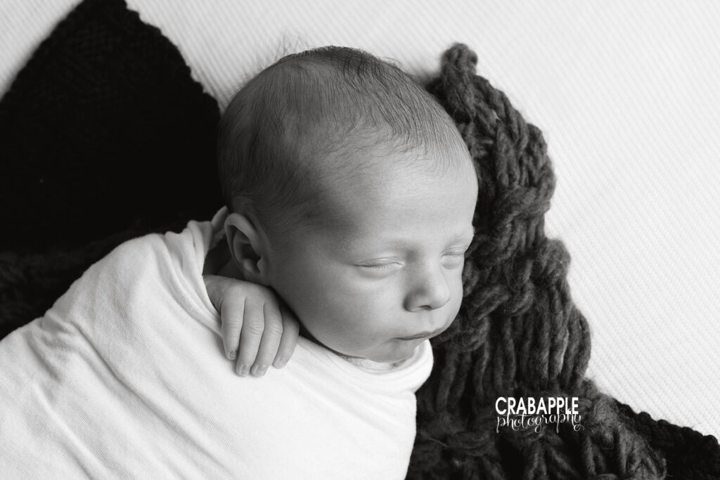 Black and white newborn photos using contrasting light and dark shades.