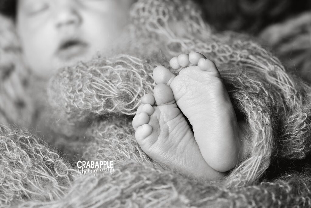 Black and white portrait of newborn baby feet using macrophotography.
