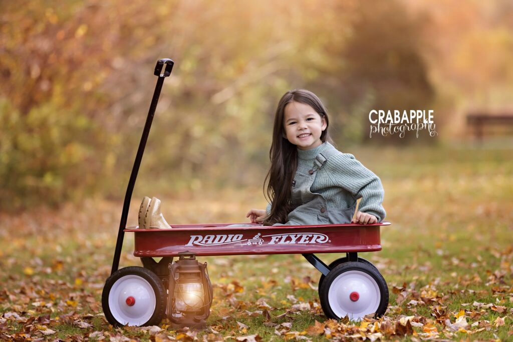 Child portrait ideas using red wagon outside during the fall in New England.