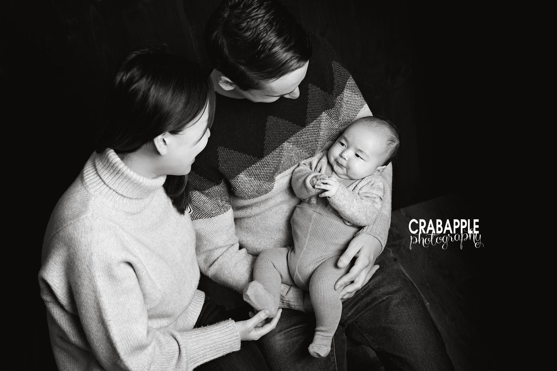 Black and white family photo inspiration of mom, dad, and baby boy taken from above.