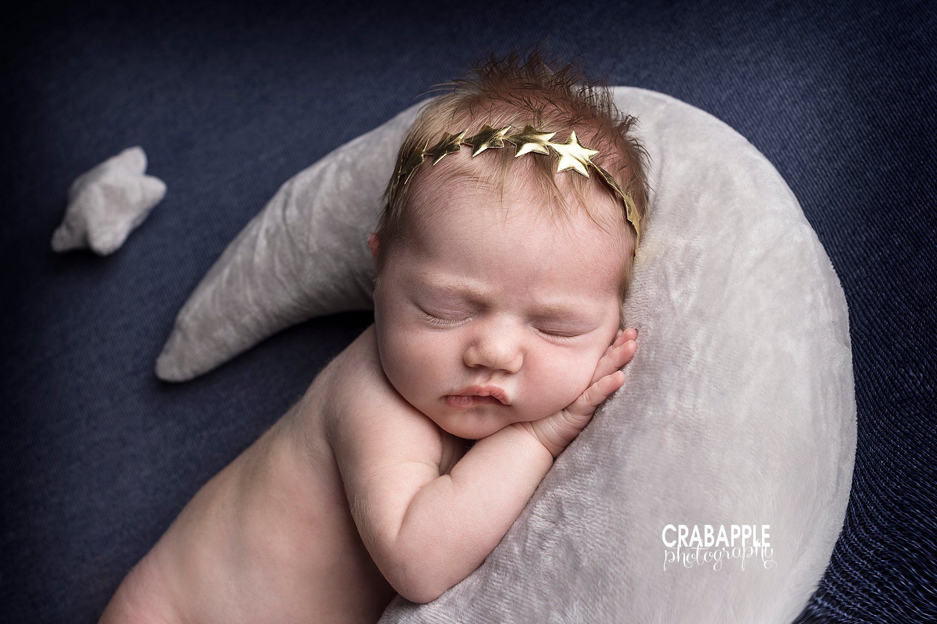 Close up of a moon and stars night sky themed newborn baby girl portrait session.