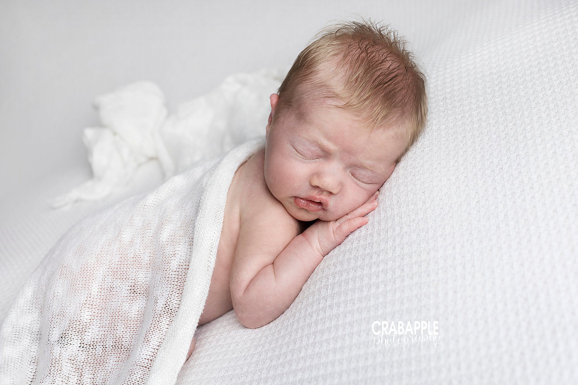 Newborn baby girl photos using all white blankets and swaddles. Clean and simple baby portrait ideas.