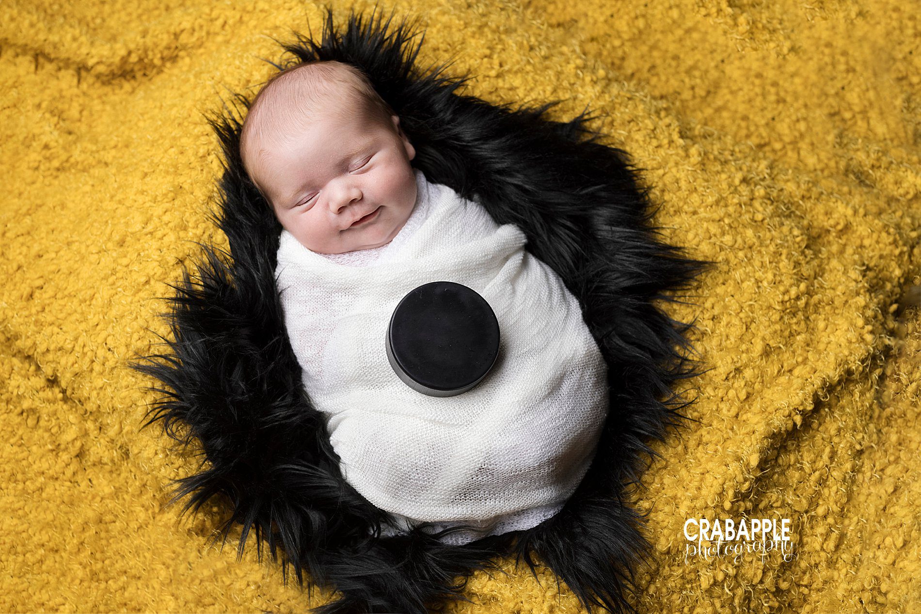 Classic and timeless Boston Bruins themed newborn photos with puck