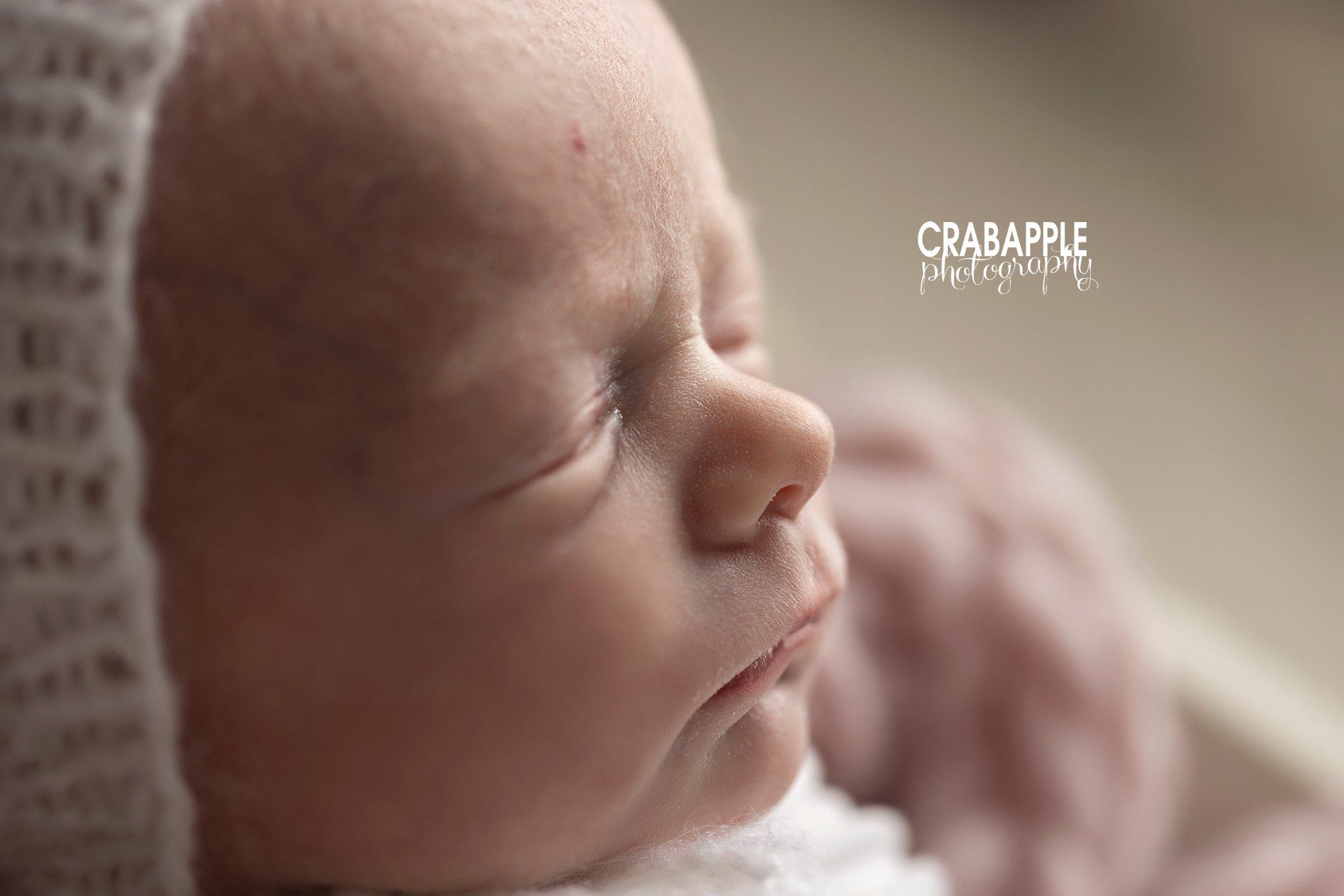 Close up profile portrait of newborn baby girl.