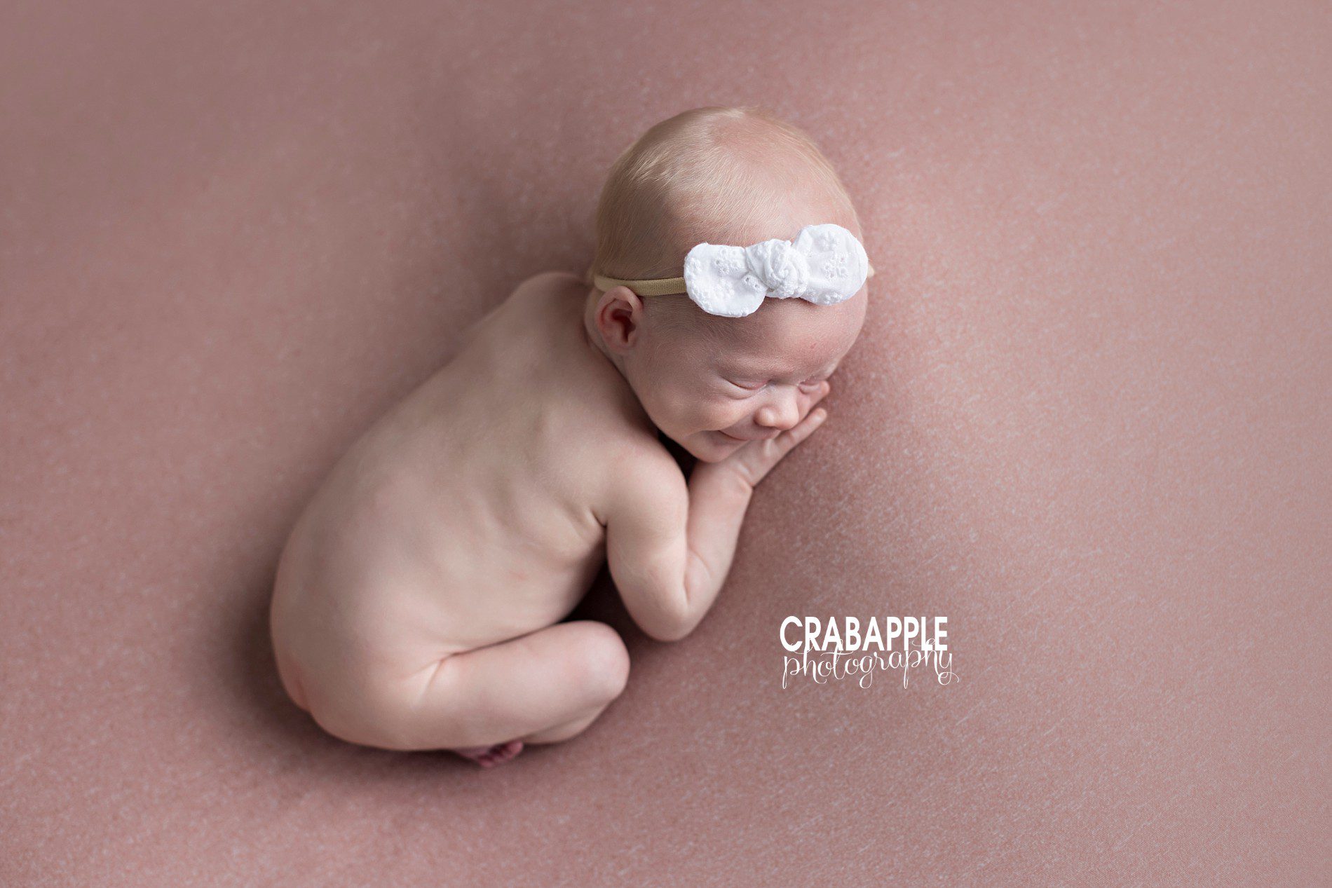 Sweet and simple professional newborn portraits using white and pink.