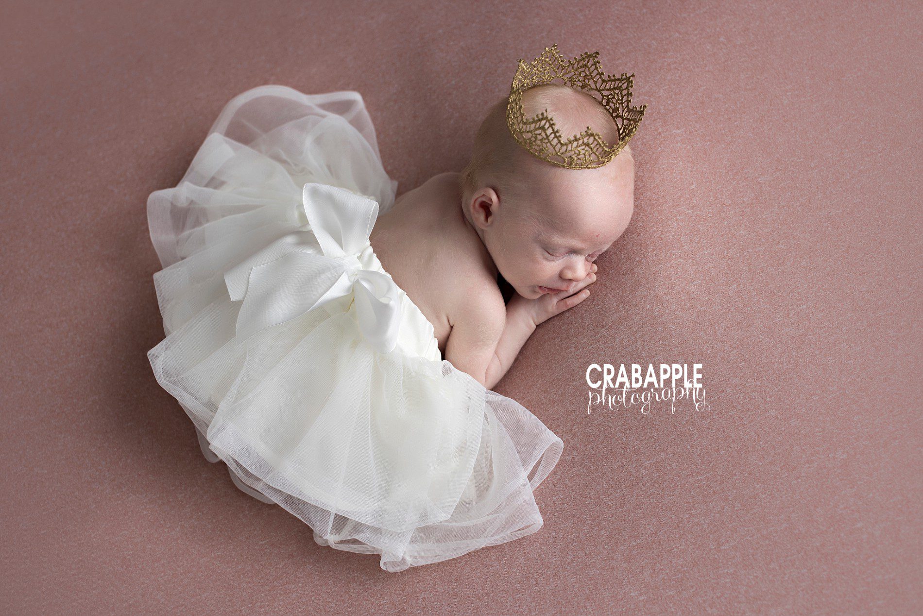 Newborn baby girl photo ideas using crown and tutu.