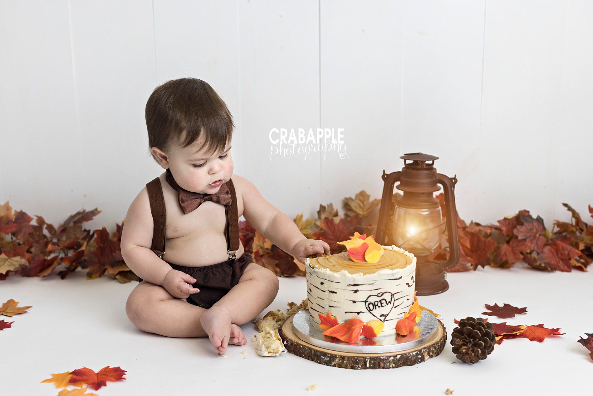 Fun and festive fall themed cake smash with oranges and browns.