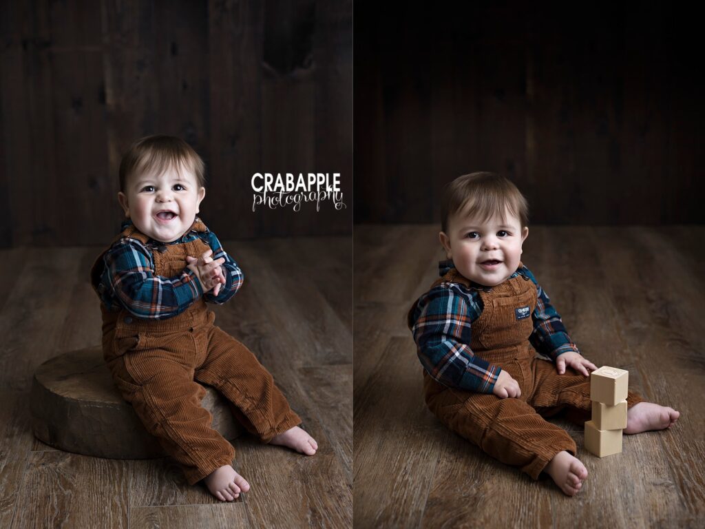 One year baby portraits in front of dark wood background. Baby is wearing brown corduroy overalls and a plaid shirt.