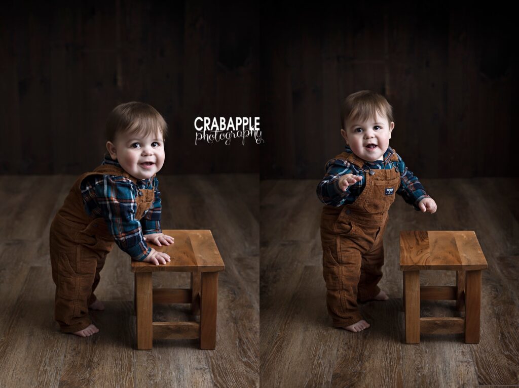 Styling and posing ideas for one year baby portraits of baby standing using a wooden stool in front of a dark wood backdrop.