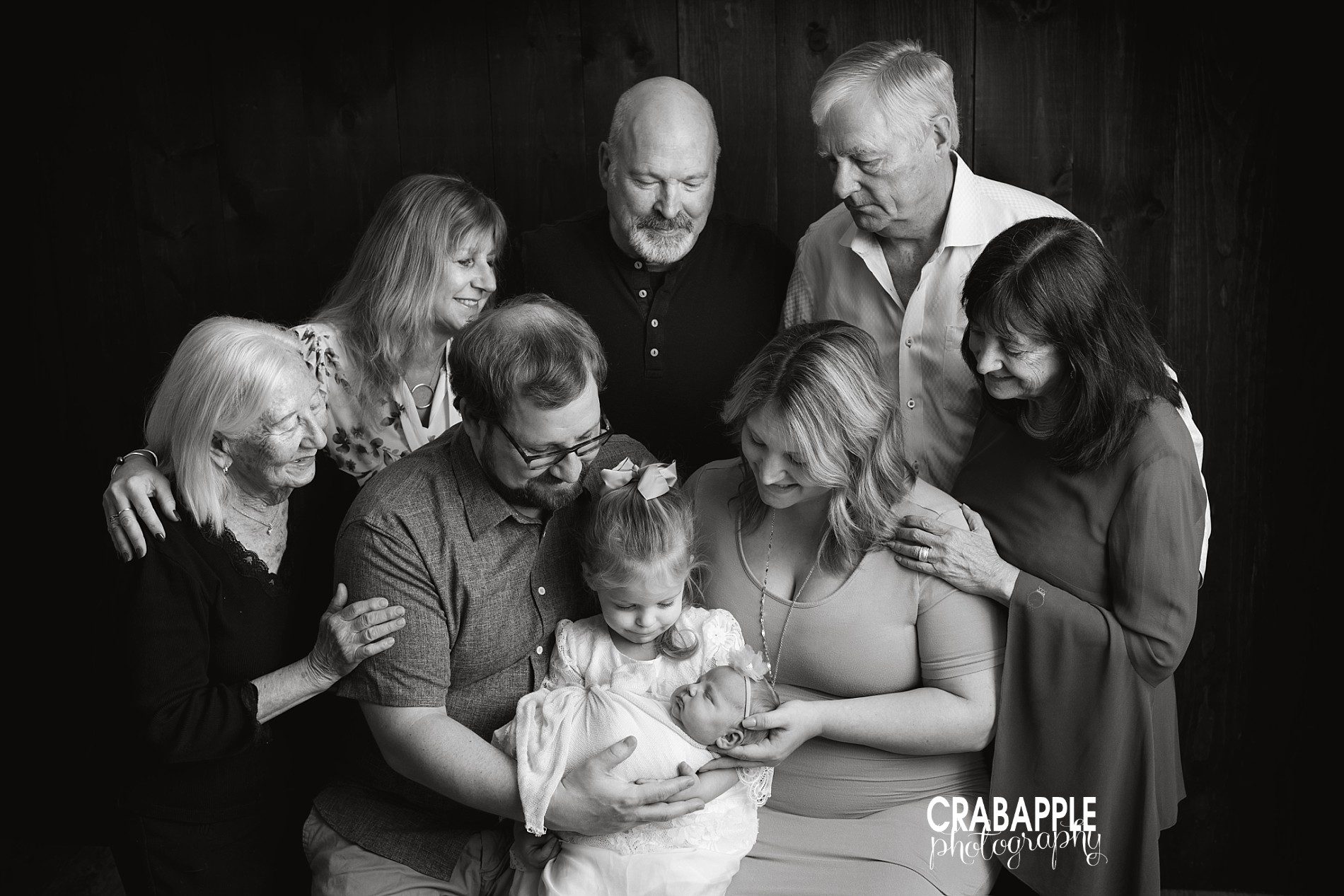 Black and white extended family portraits with newborn.