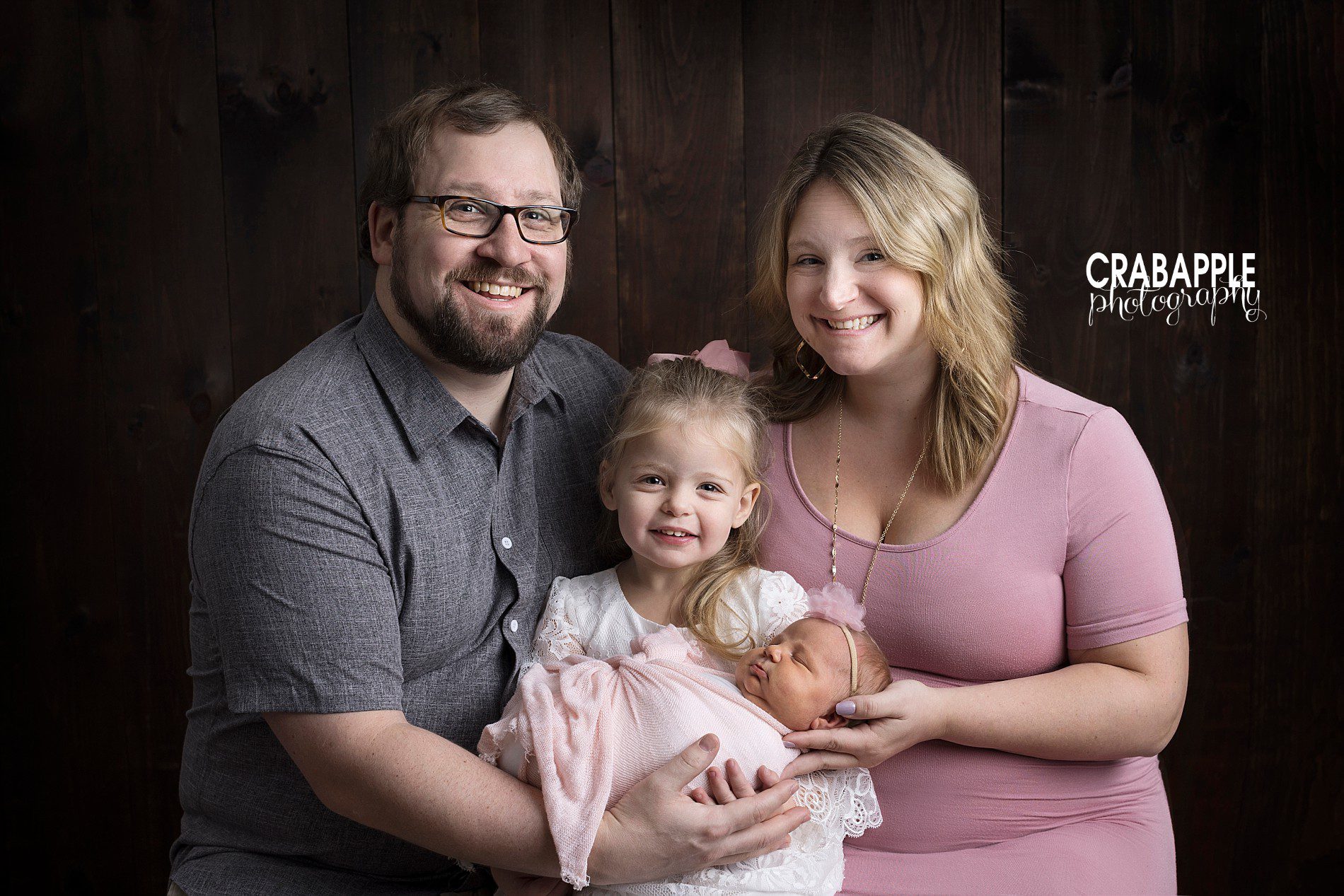Family of four photos, mom, dad, toddler sister and newborn baby sister.