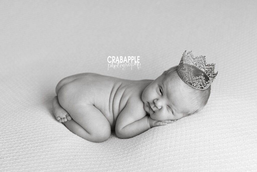 Black and white newborn portrait using a small crown.