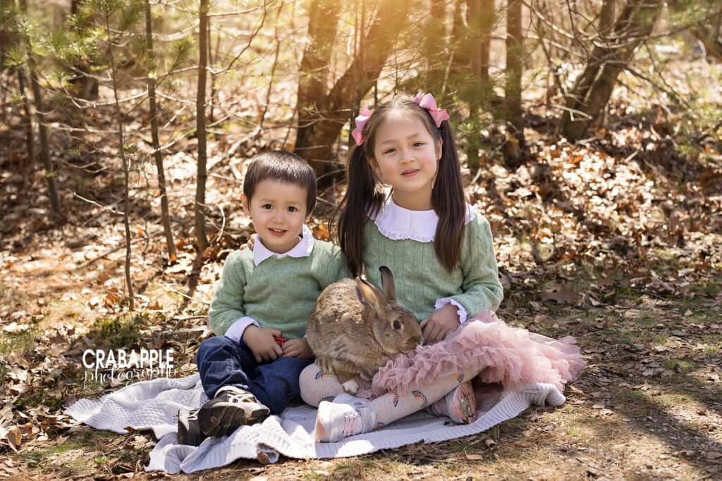 Sibling photos including older sister and younger brother in matching light green sweaters smiling at the camera with a bunny in their lap.