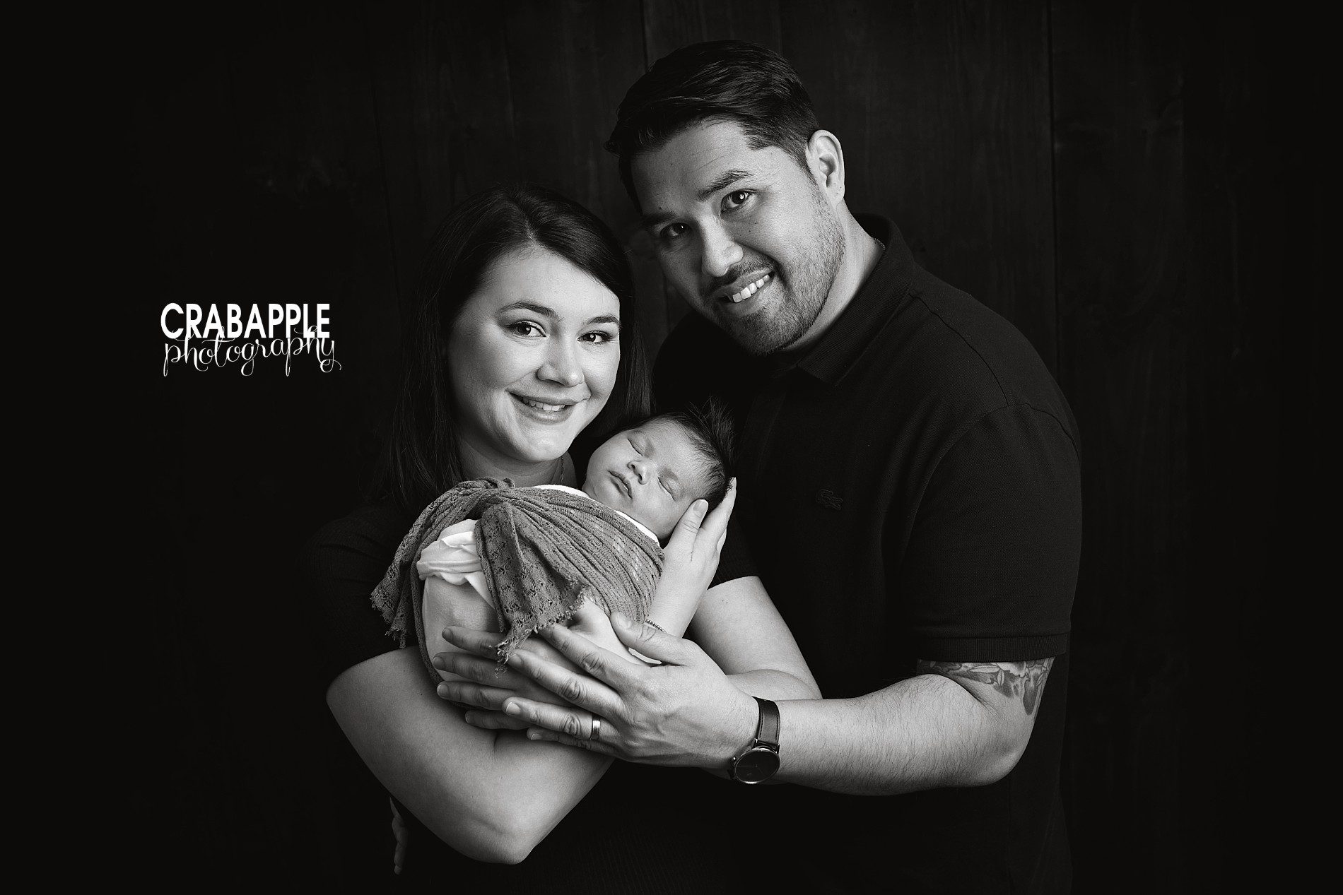 family poses for newborn photos 