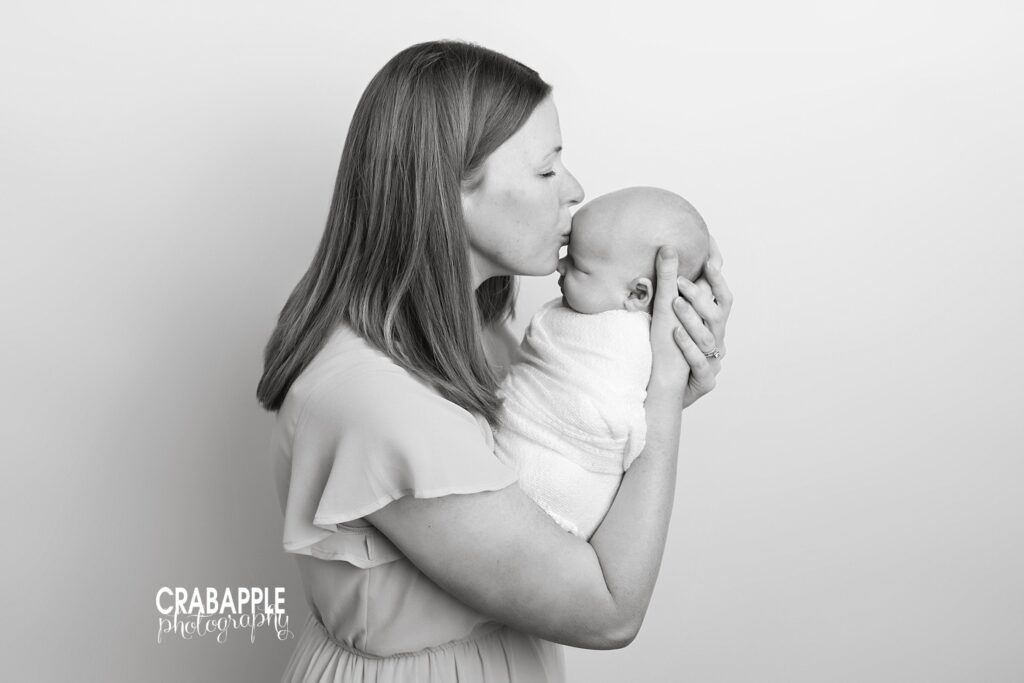 Mother and newborn poses for portraits