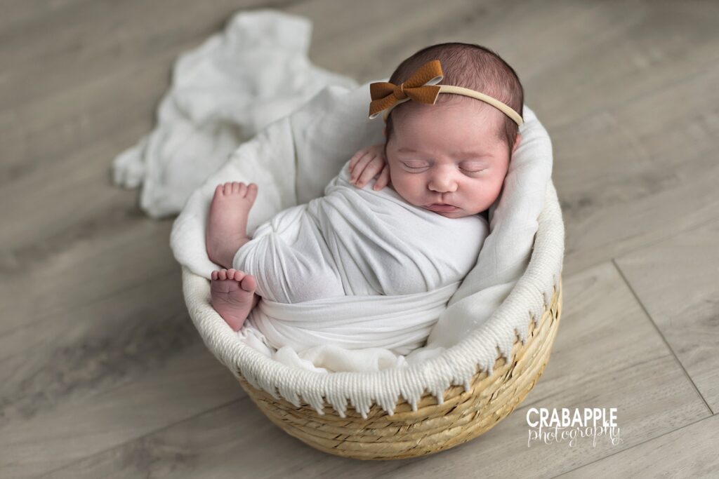 Simple, neutral newborn baby girl photos with props and accessories.