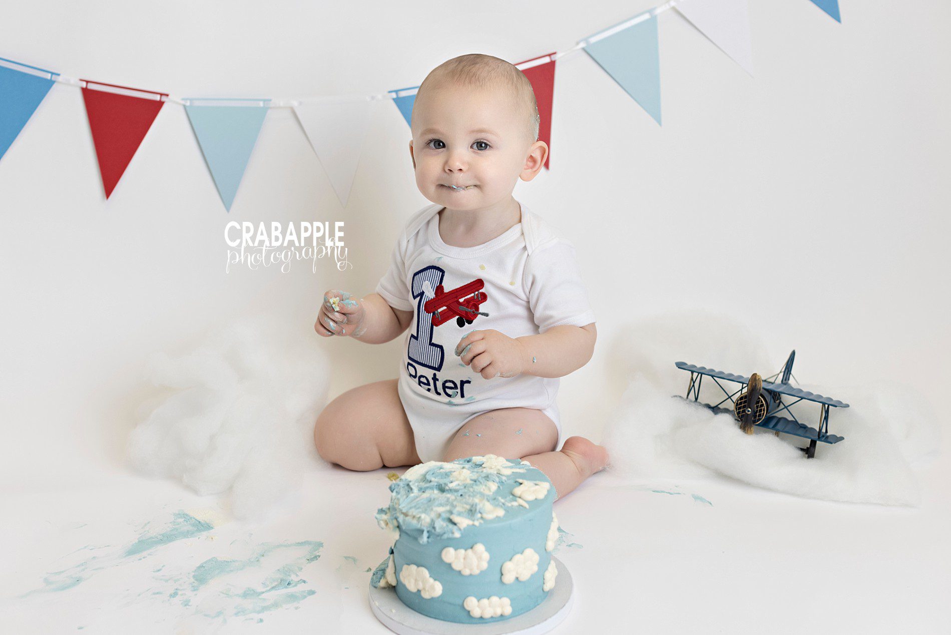 red and blue plane themed cake smash inspiration