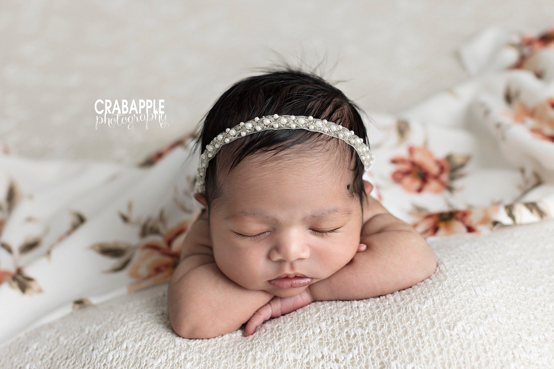newborn photos with baby's head resting on arms
