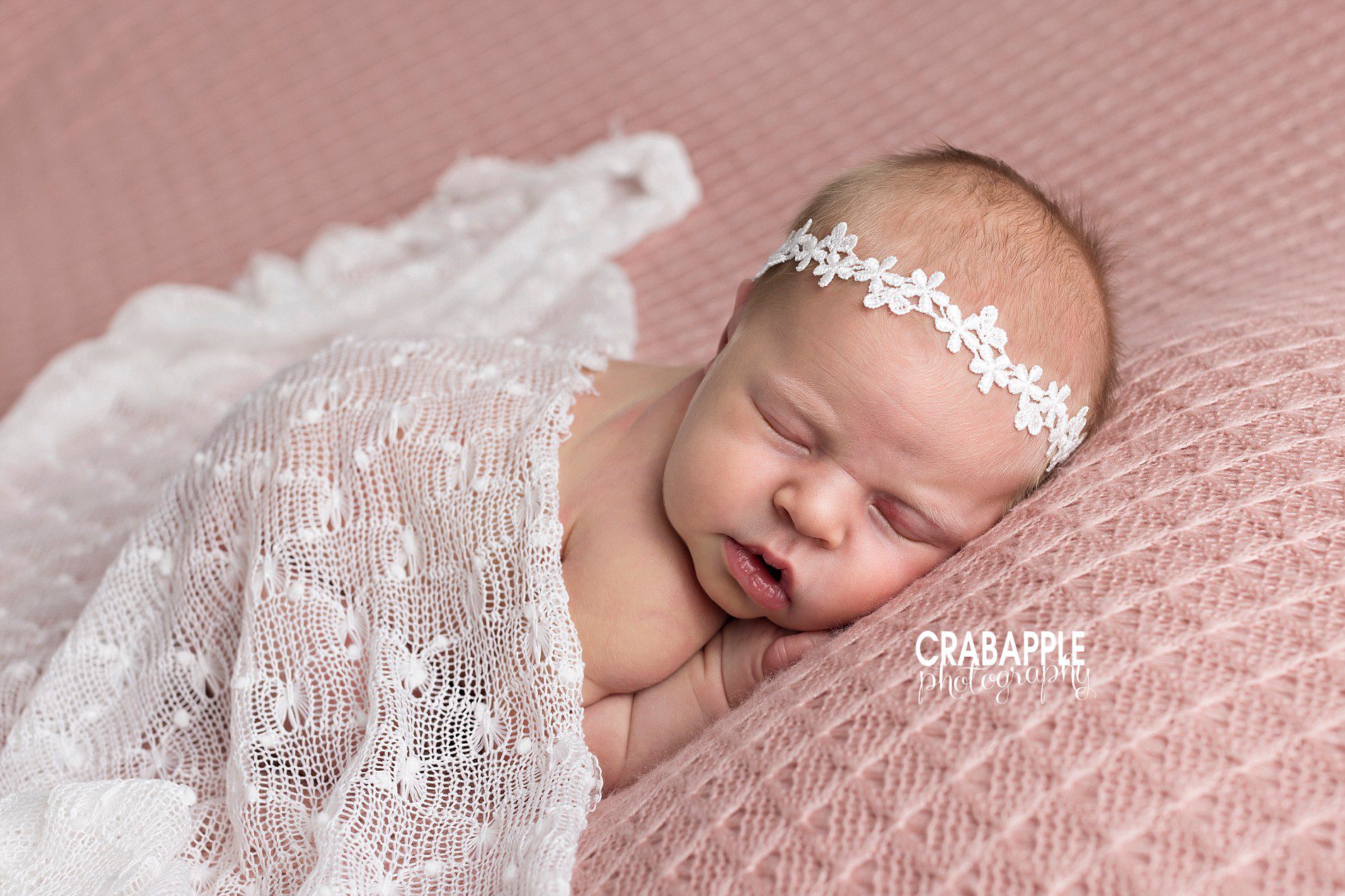 pink newborn photos with lace and flowers