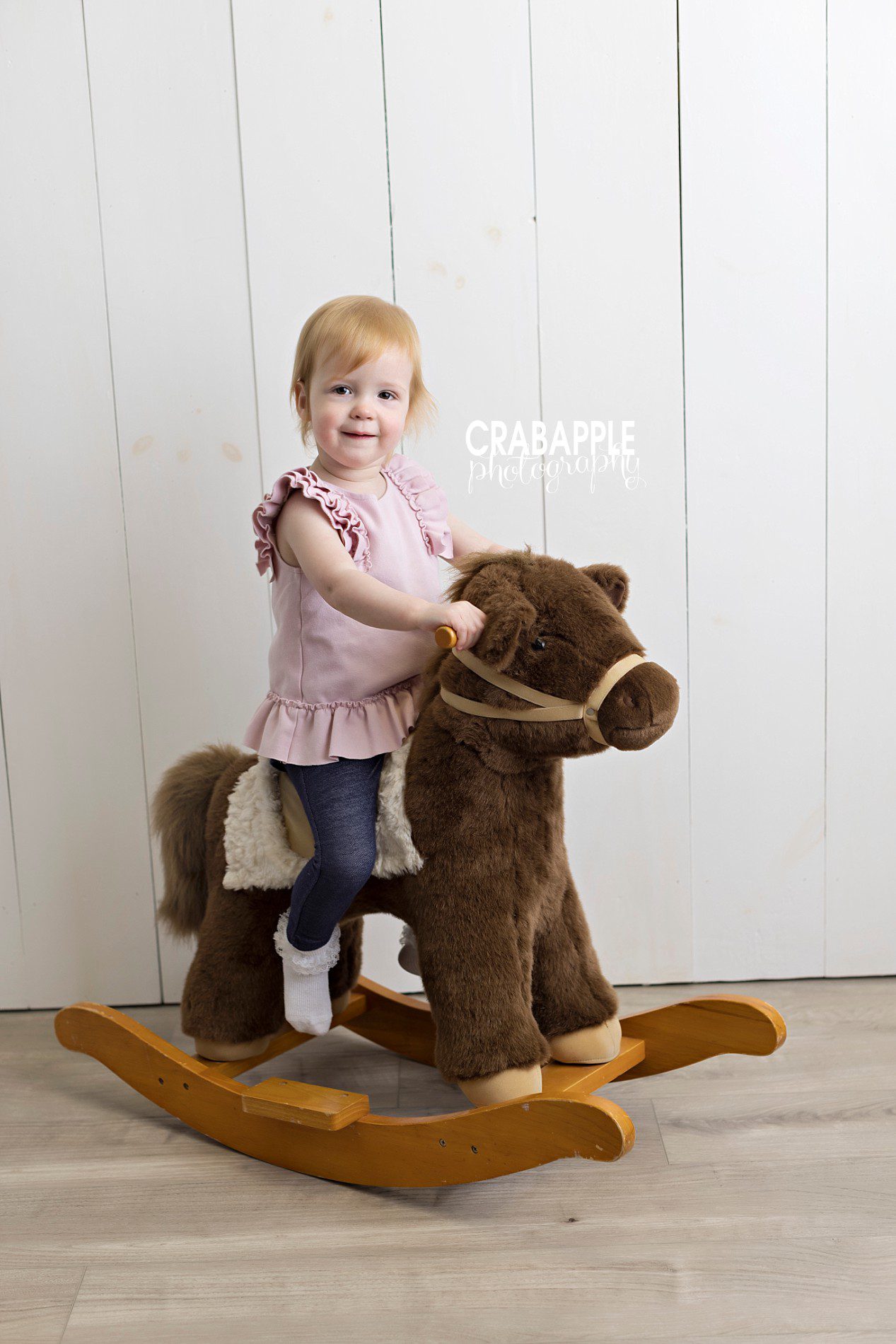 fun accessories for toddler portrait photography in a photo studio