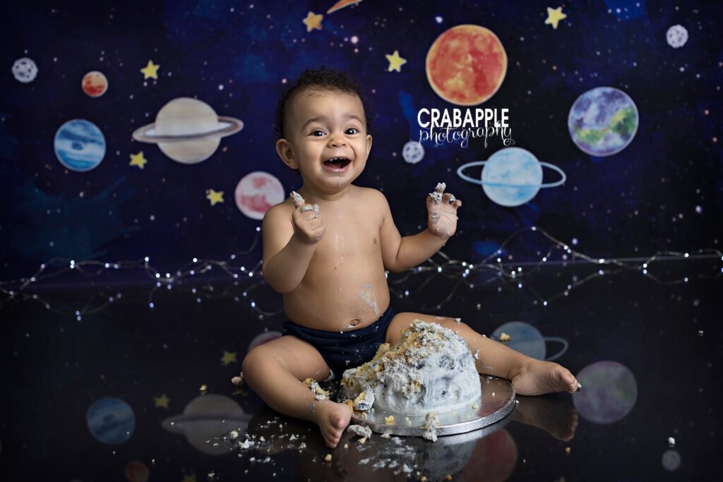 First trip around the sun cake smash setup with celestial decorations
