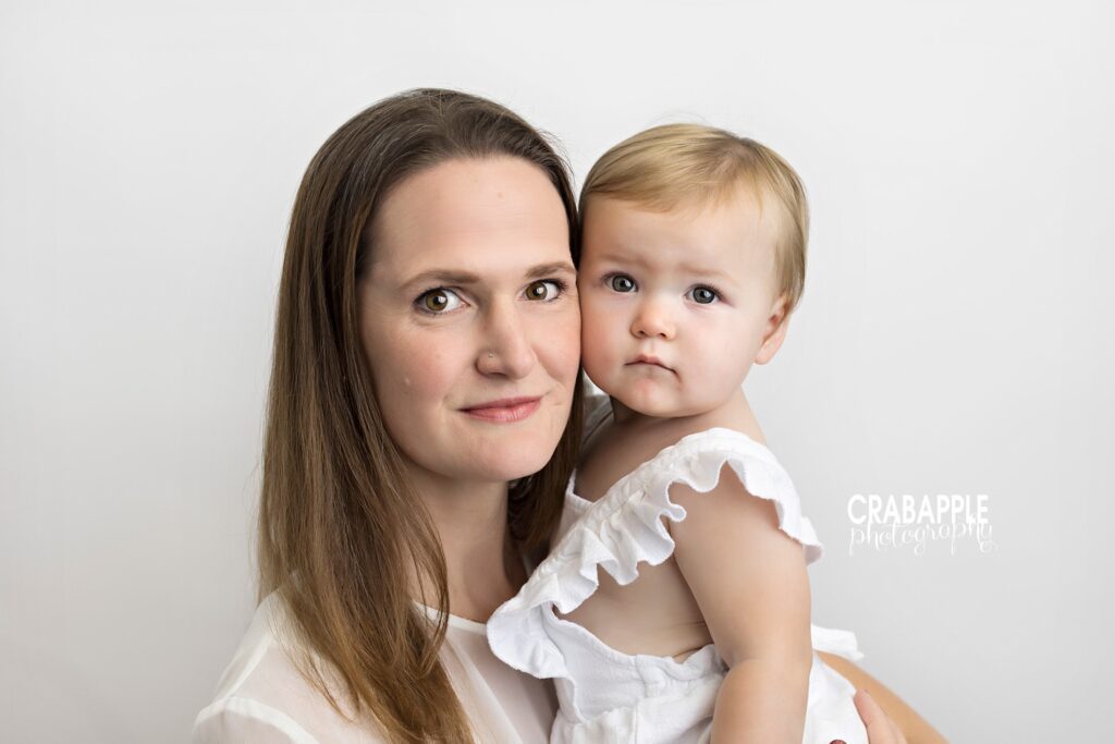 close up portrait of one year old girl  and mom in studio setting near Boston
