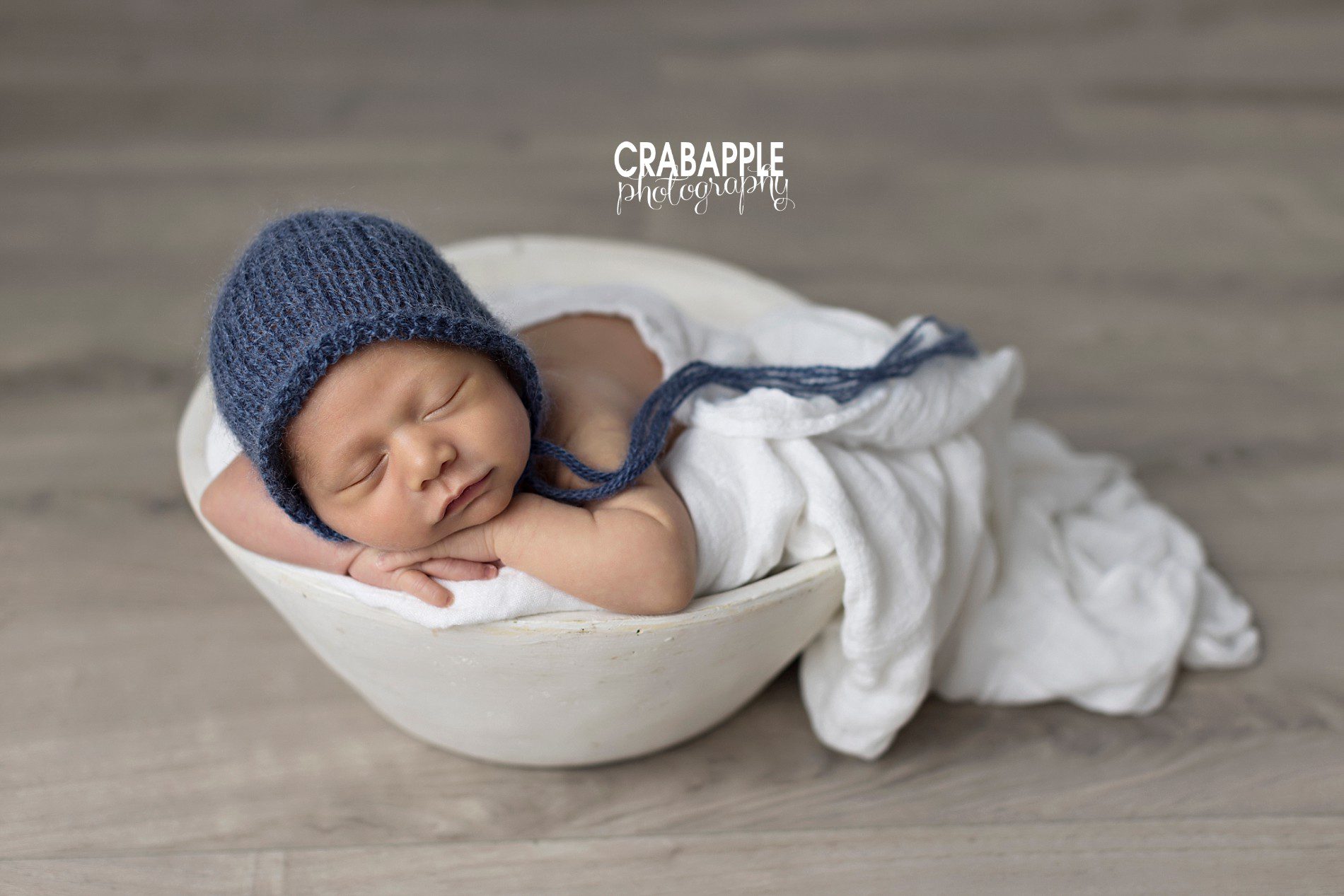 using a wooden bowl for newborn photos