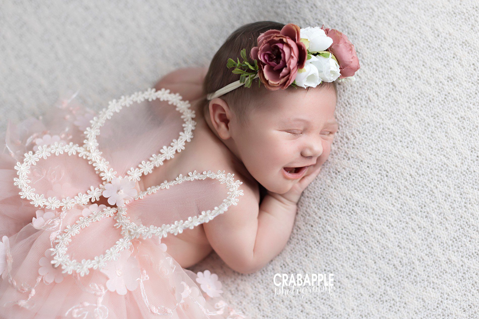 ideas for whimsical newborn photos for girls using flower headband and fairy wings
