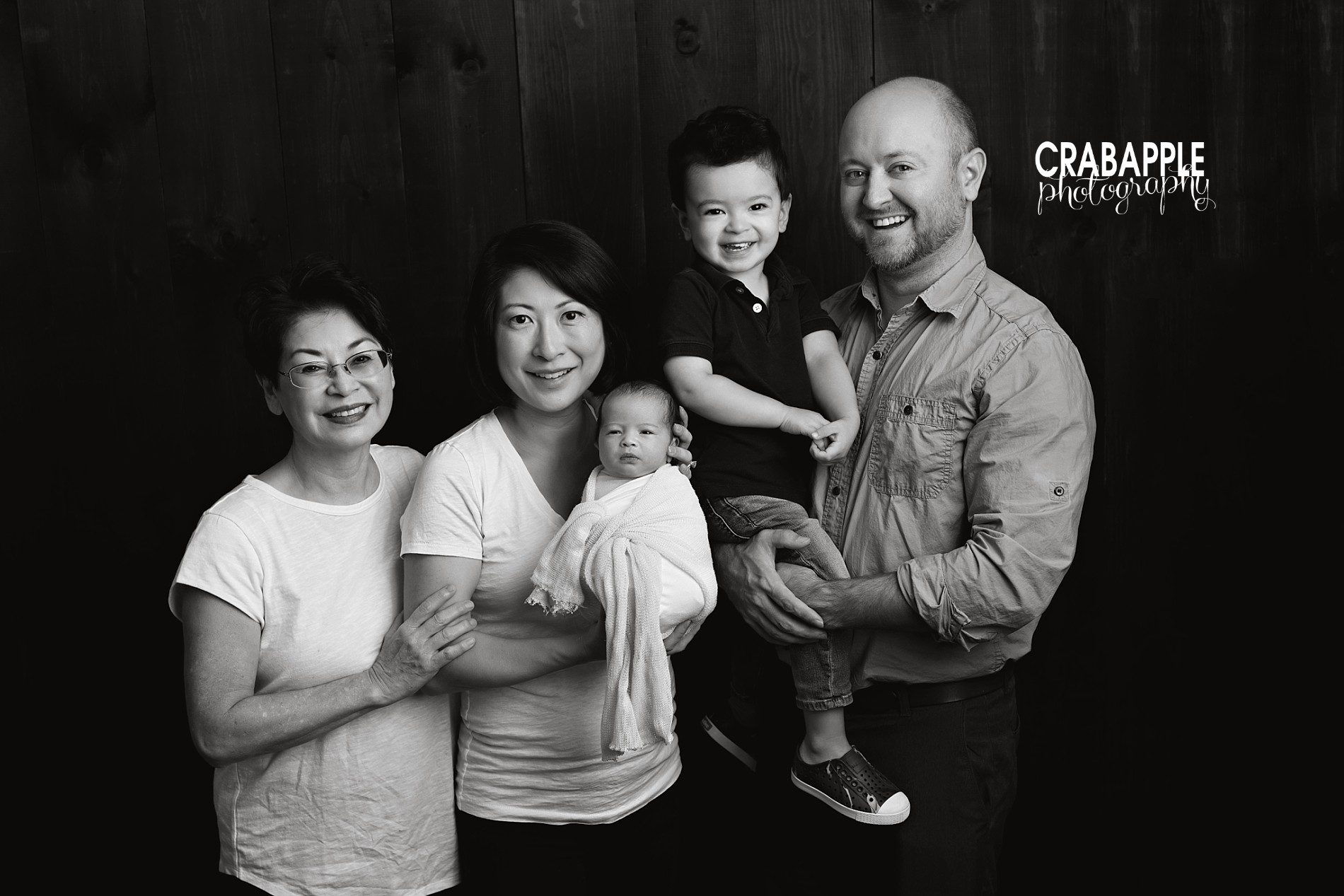 black and white family photos with newborn and grandmother