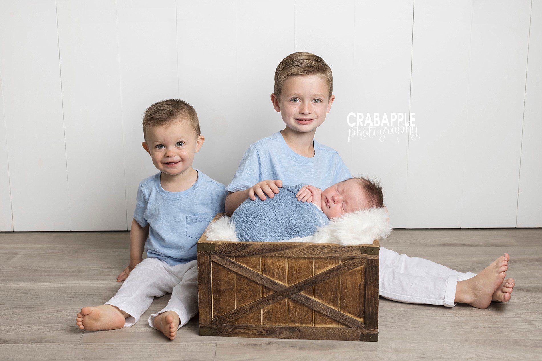 newborn and brother photos using blue and white color palette