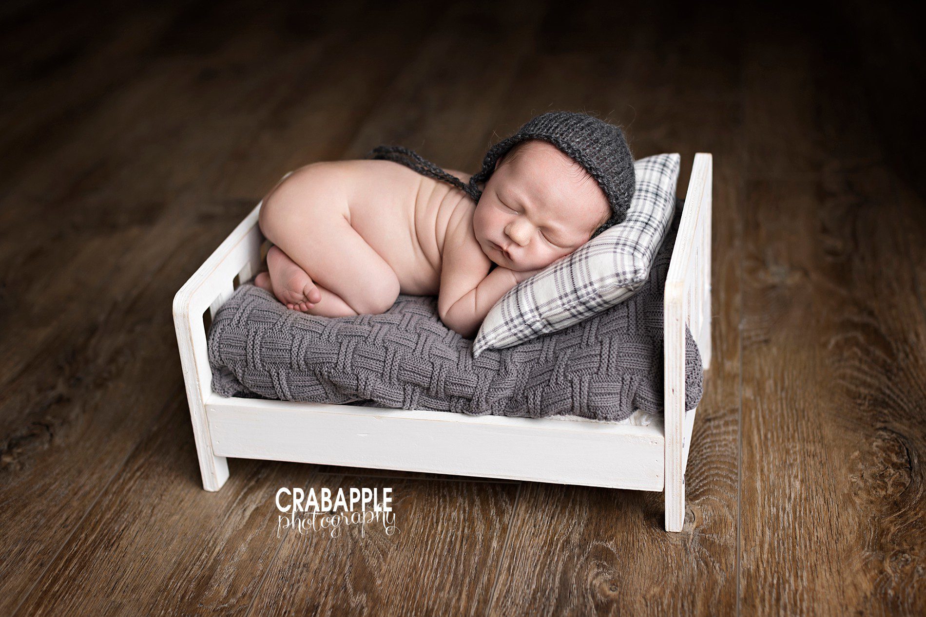 newborn photos with little bed prop