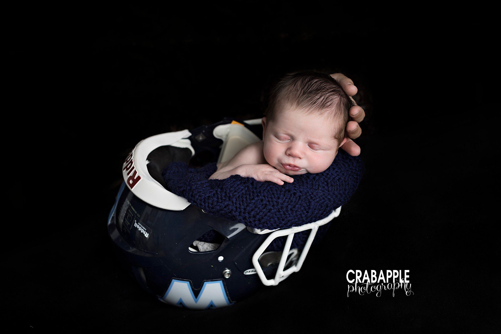 newborn photos with football helmet