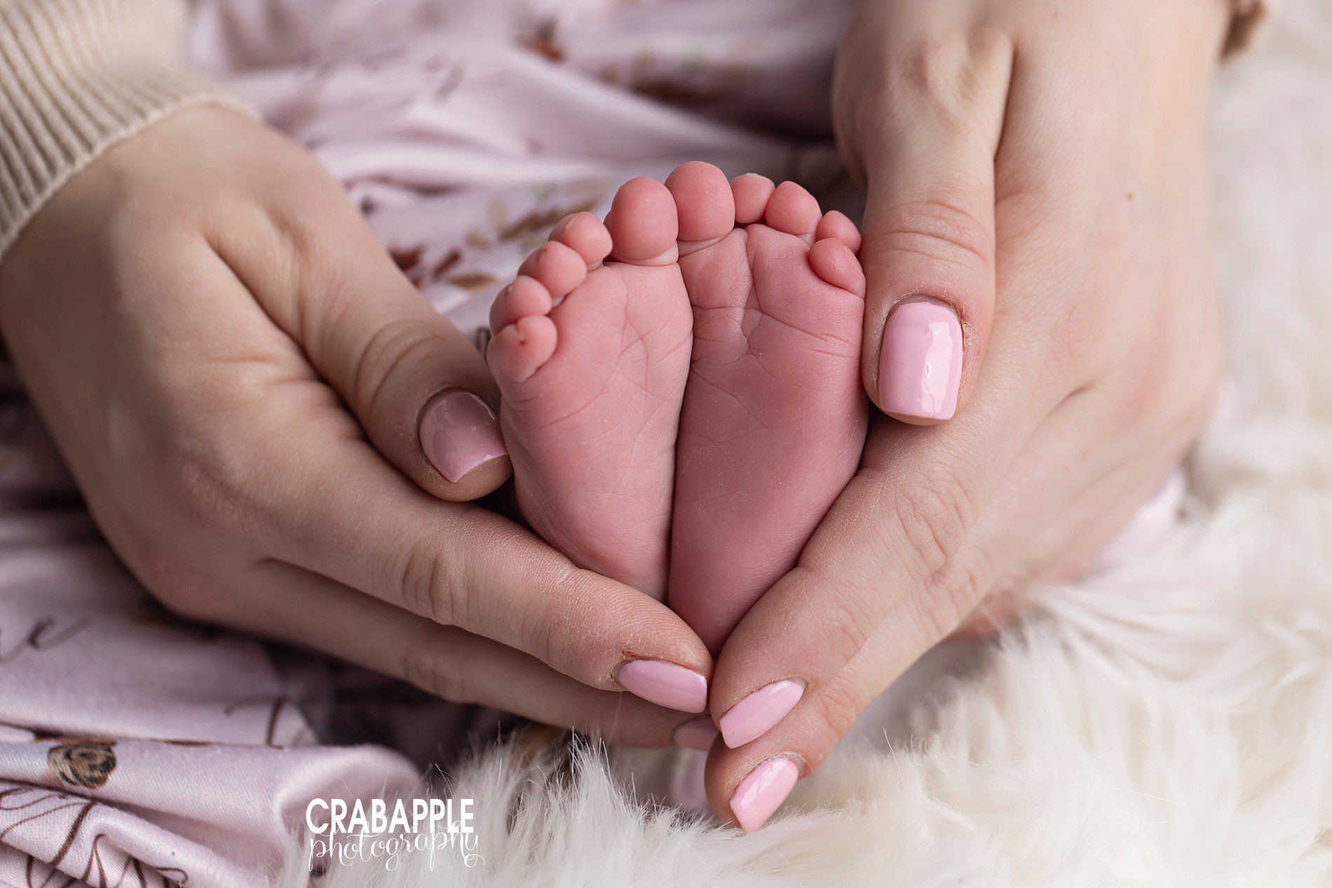 mom's hands and newborn's feet