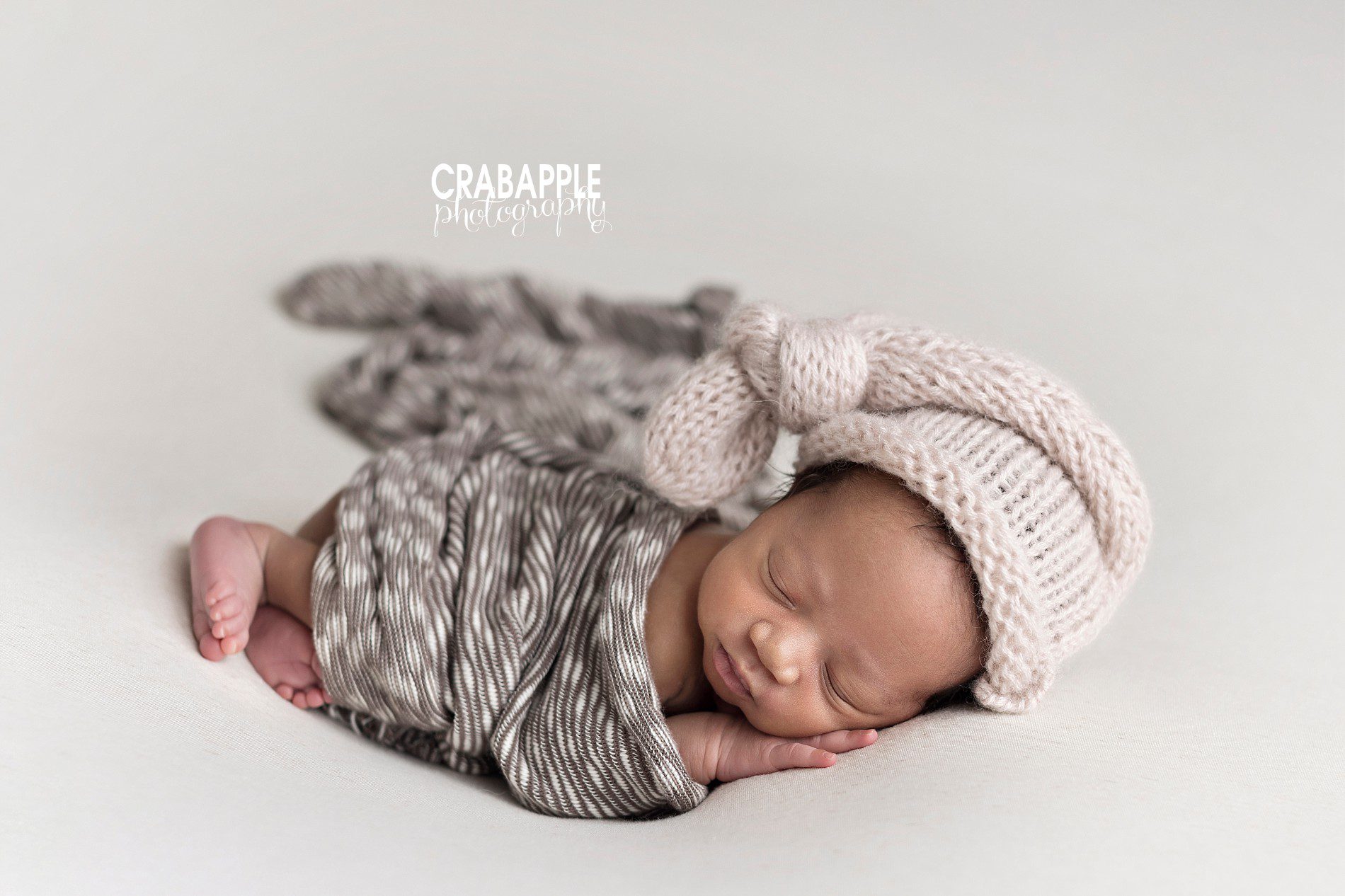 neutral newborn photo styling using brown and cream