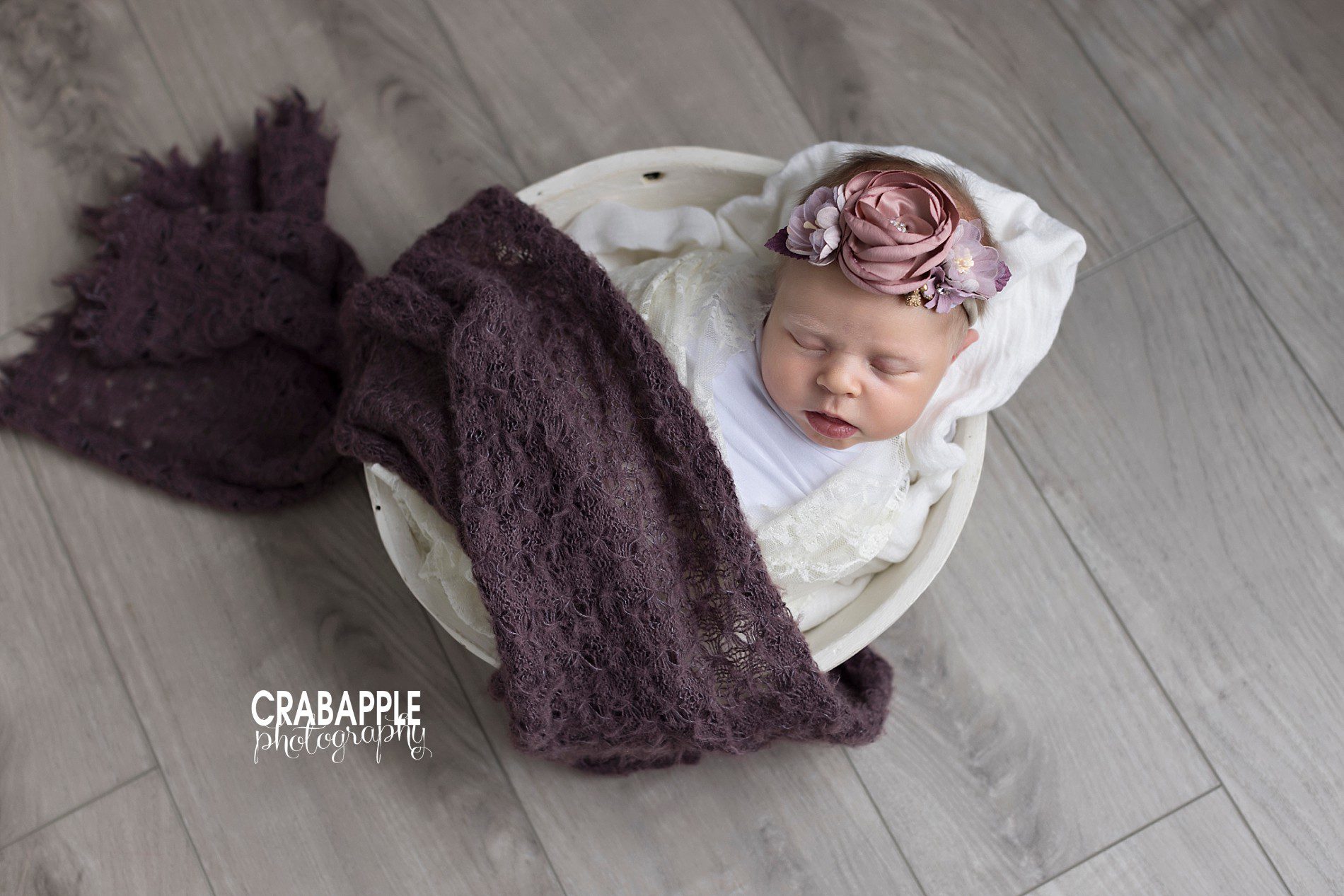 white newborn photo styling with pops of purple