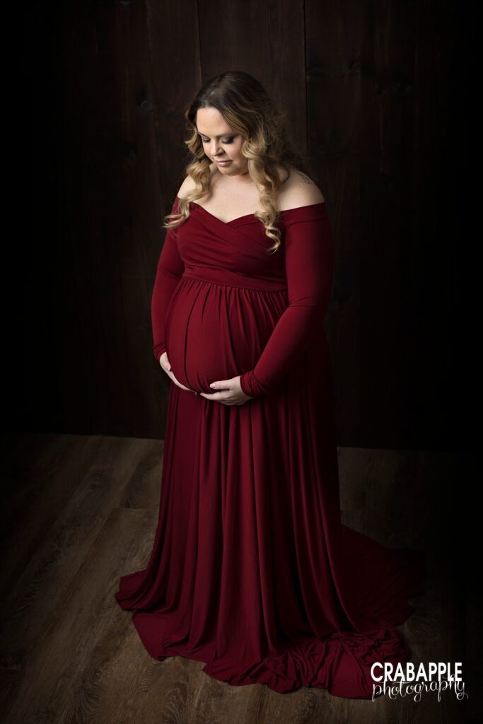 Dark red dress for moody dramatic maternity photos