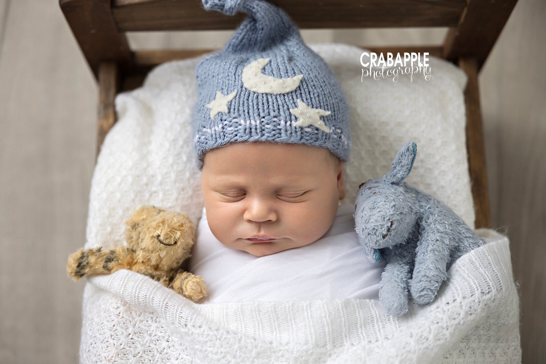 newborn photos using a bed for a prop