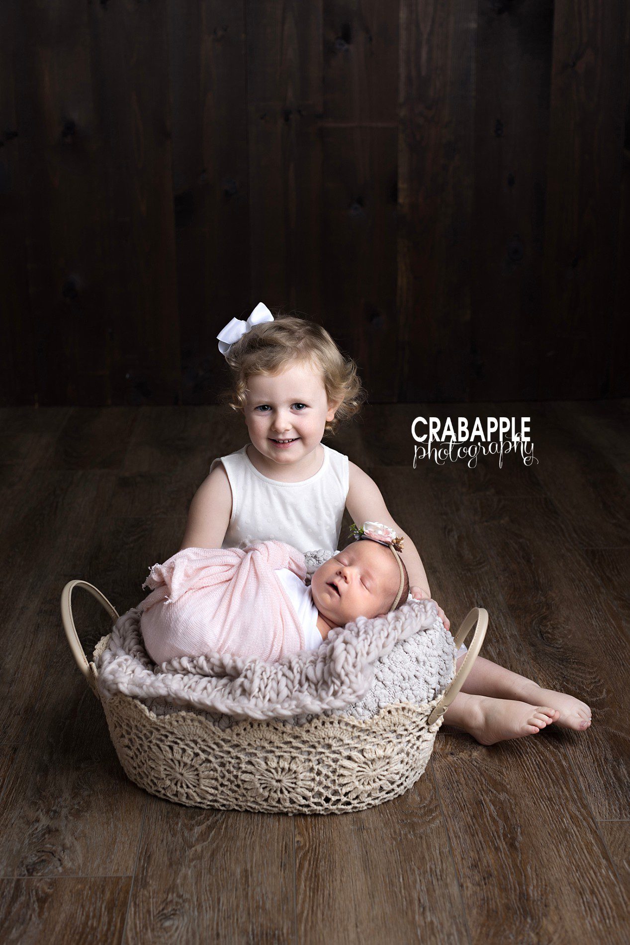 toddler and newborn sister photos
